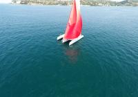 red gennaker sail white trimaran neel 45 blue sea
